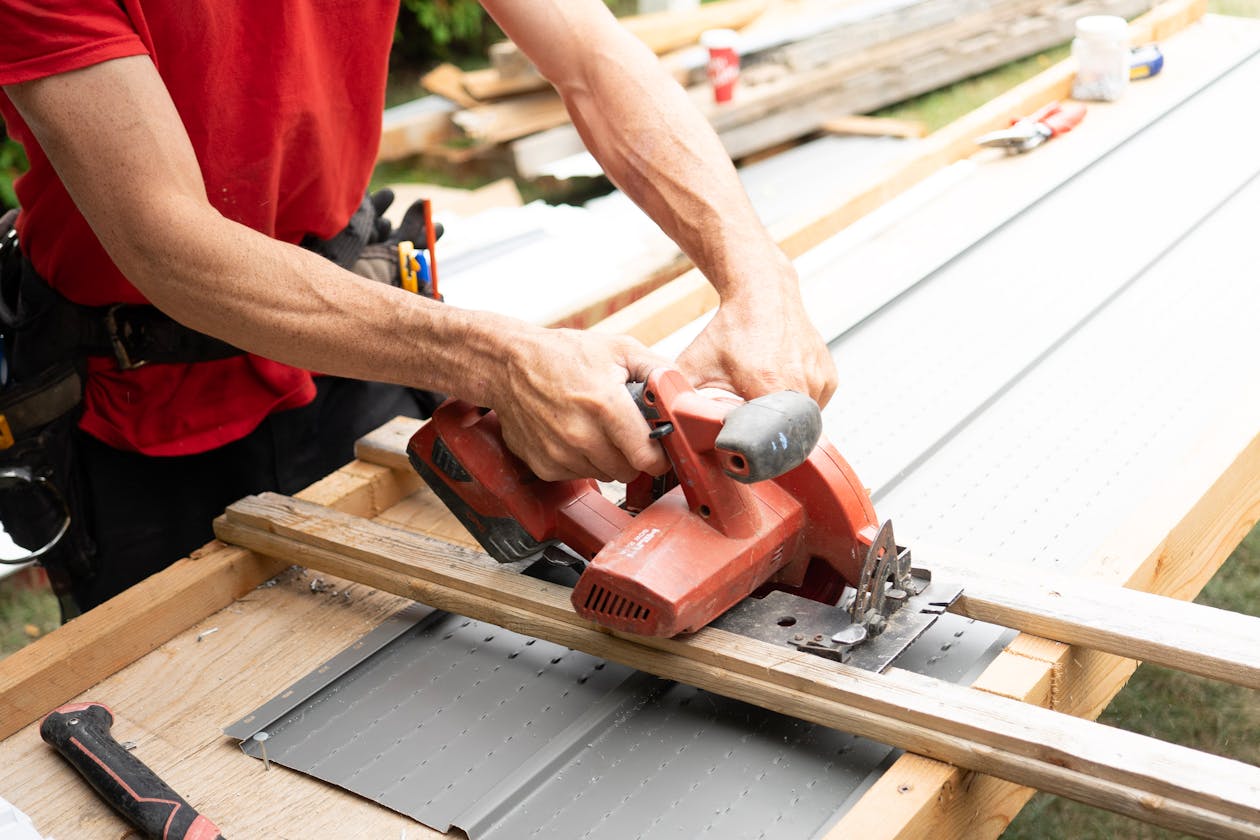 Carpenter using a circular saw on a construction site, the kind of NZ tradie work that leaves no time for admin