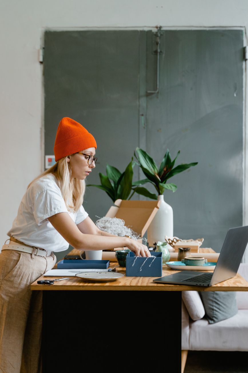 Solopreneur working at her desk on the kind of repetitive admin you can automate with Make.com