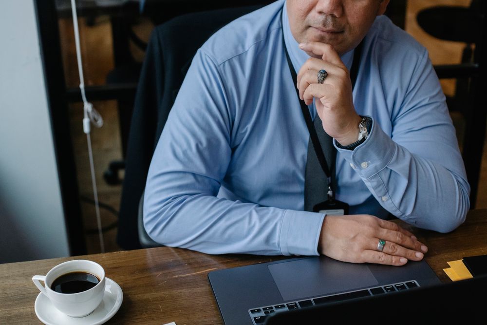 NZ small business owner thinking through where to start with AI while working on a laptop in the office